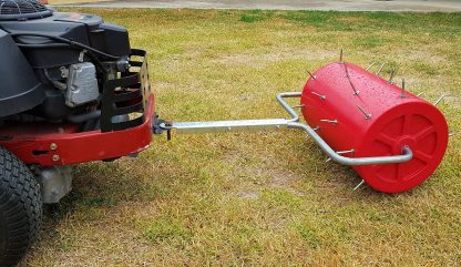 Lawn aerator with pull handle and tow bracket